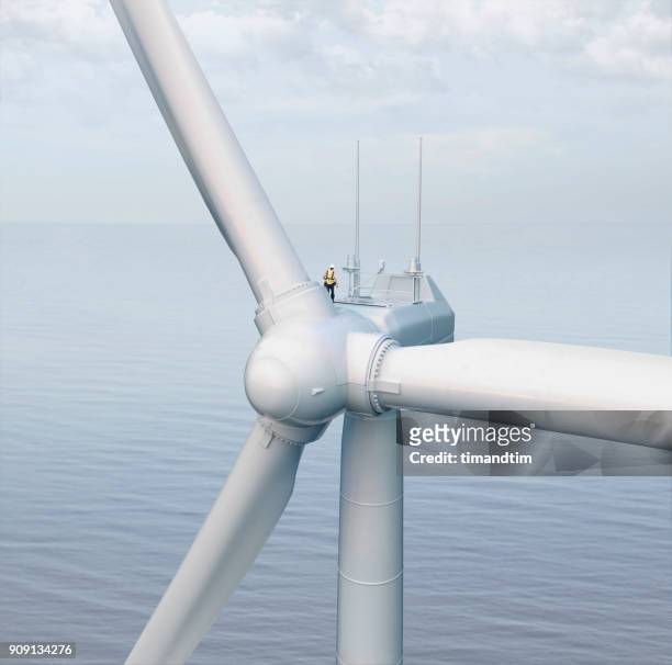 wind turbine in the sea with a technician - wind power stock pictures, royalty-free photos & images