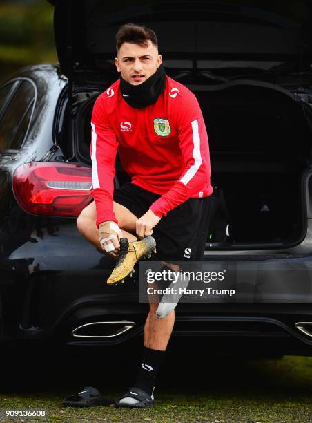 Otis Khan of Yeovil Town puts on his boots in the back of his car prior to a training session during the Yeovil Town media access day at Huish Park...