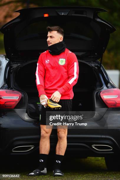 Otis Khan of Yeovil Town puts on his boots in the back of his car prior to a training session during the Yeovil Town media access day at Huish Park...