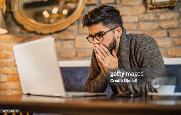 young man looking at computer. - impatient stock pictures, royalty-free photos & images