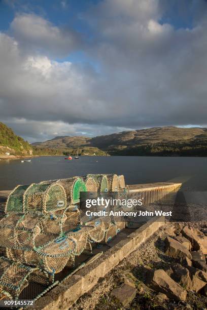 lobster and crab creels stacked at shieldaig harbour, west coast of scotland - shieldaig stock pictures, royalty-free photos & images