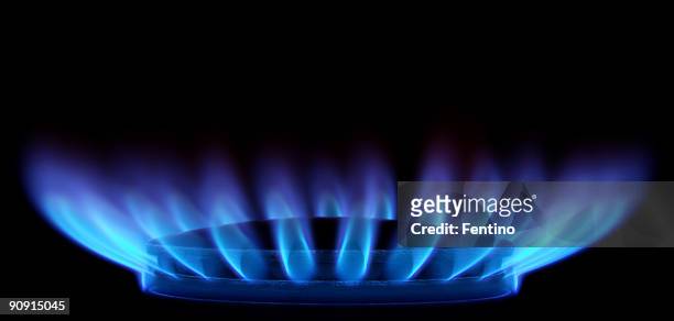 blue flames in black (gas stove from side) - hob stock pictures, royalty-free photos & images