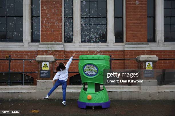 Girl jumps after bubbles during the 2018 London Toy Fair at Olympia Exhibition Centre on January 23, 2018 in London, England. The annual fair which...