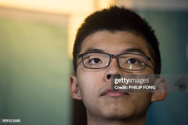 Pro-democracy activist Joshua Wong stands before the press after he was granted bail at the High Court in Hong Kong on January 23, 2018. - Hong Kong...