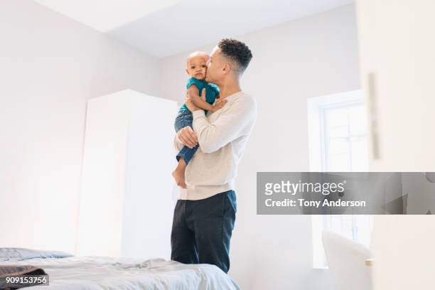 Young father and infant daughter at home