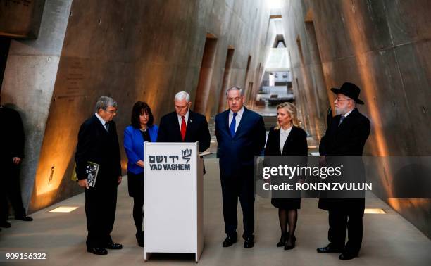 Vice President Mike Pence signs the guestbook at Yad Vashem Holocaust History Museum in Jerusalem January 23 accompanied by his wife Karen Pence ,...