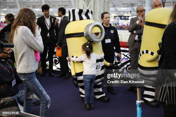 Girl hugs a life size cartoon character during the 2018 London Toy Fair at Olympia Exhibition Centre on January 23, 2018 in London, England. The...