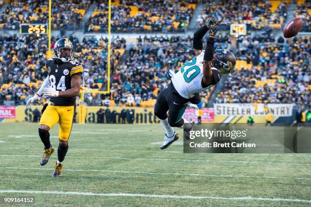 Antonio Brown of the Pittsburgh Steelers watches as Jalen Ramsey of the Jacksonville Jaguars nearly intercepts a pass thrown by Ben Roethlisberger...