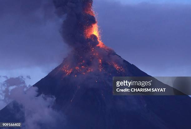 The Mayon volcano spews lava as it continues to erupt, as seen from Legazpi City in Albay province, south of Manila on January 23, 2018. Intense lava...