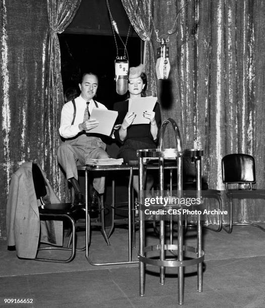 Actors Myrna Loy and William Powell at rehearsal in the Lux Radio Theater studio. They prepare to perform Hired Wife, based on the 1940 theatrical...