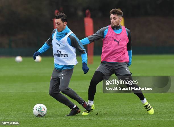 Mesut Ozil and Mathieu Debuchy of Arsenal during a training session at London Colney on January 23, 2018 in St Albans, England.