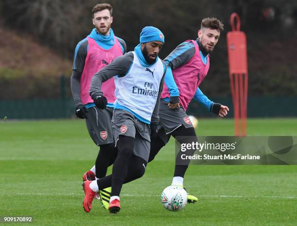 Alex Lacazette and Mathieu Debuchy and during a training session at London Colney on January 23, 2018 in St Albans, England.