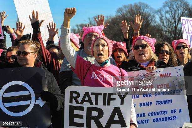 People gather at the Lincoln Memorial reflecting pool to rally before the Women's March on January 20, 2018 in Washington, D.C. Across the nation,...