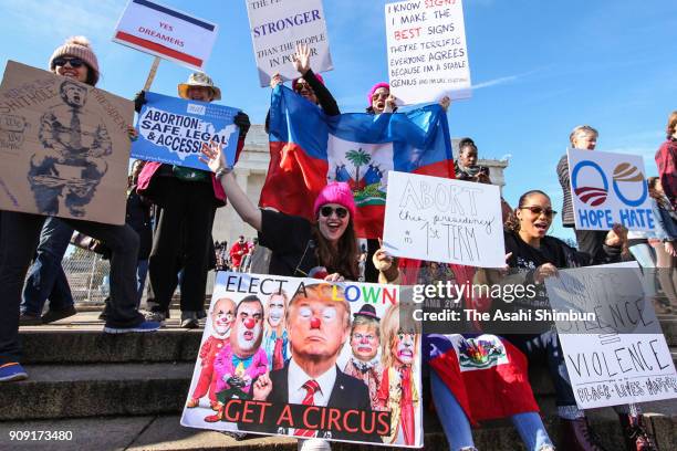 People gather at the Lincoln Memorial reflecting pool to rally before the Women's March on January 20, 2018 in Washington, D.C. Across the nation,...