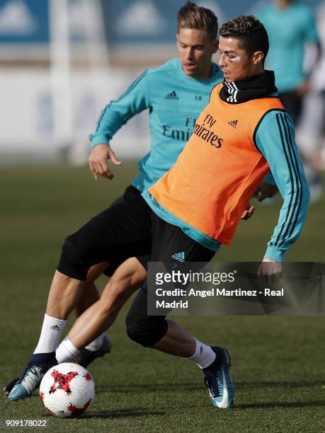 Cristiano Ronaldo and Marcos Llorente of Real Madrid in action during a training session at Valdebebas training ground on January 23, 2018 in Madrid,...