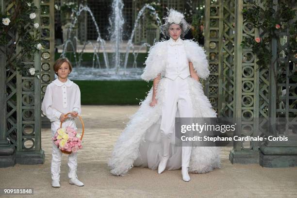 Hudson Kroenig and a model walk the runway during the Chanel Spring Summer 2018 show as part of Paris Fashion Week on January 23, 2018 in Paris,...