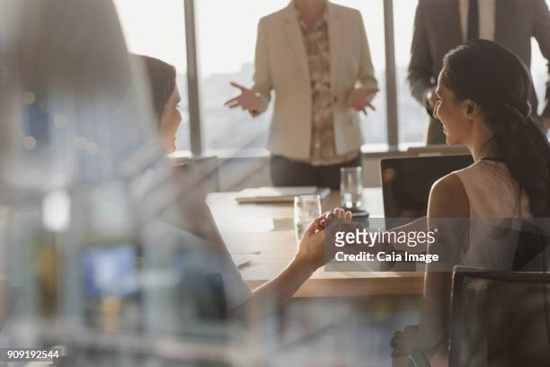 businesswomen shaking hands in conference room meeting - first exposure series stock pictures, royalty-free photos & images