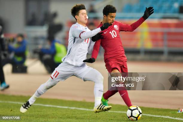 Akram Afif of Qatar and Do Duy Manh of Vietnam compete for the ball during the AFC U-23 Championship semi-final match between Qatar and Vietnam at...