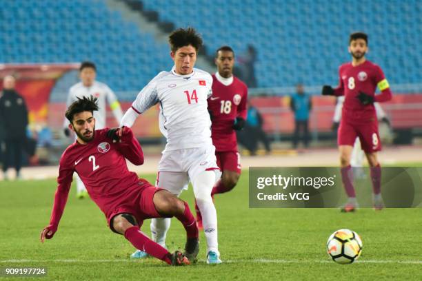 Tarek Salman of Qatar and Phan Van Duc of Vietnam compete for the ball during the AFC U-23 Championship semi-final match between Qatar and Vietnam at...