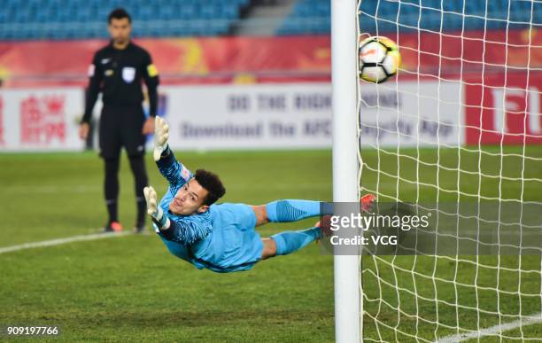 Goalkeeper Mohammed Al Bakari of Qatar fails to save a penalty kick during the AFC U-23 Championship semi-final match between Qatar and Vietnam at...