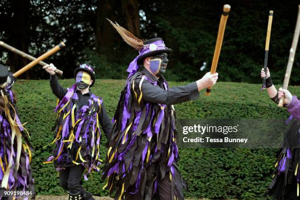 Rack-a-back Morris Men dancing a stick dance at an orchard-visiting wassail at Sledmere House, Yorkshire Wolds, UK on 20th January 2018. Wassail is a...