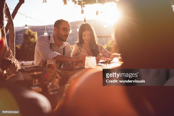 young happy friends having lunch at mediterranean countryside cottage - evening meal restaurant stock pictures, royalty-free photos & images