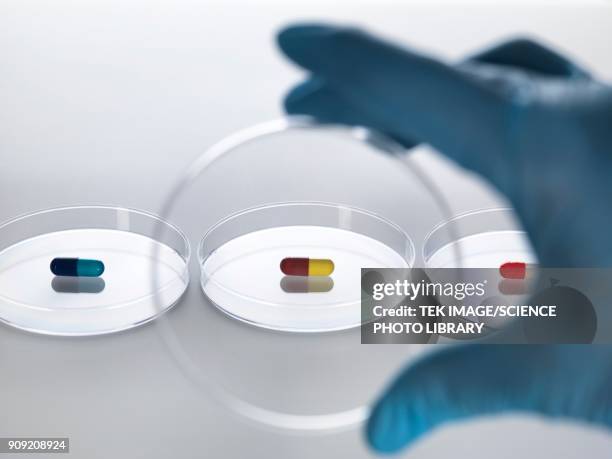 pharmaceutical research, conceptual image - hand holding several pills photos et images de collection