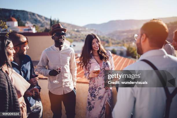 young multi-ethnic friends drinking wine and beer in rustic village - winery people stock pictures, royalty-free photos & images