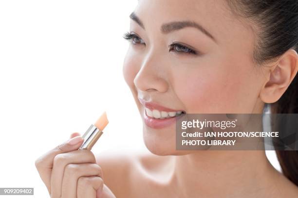 woman applying lipstick portrait - concealer stock pictures, royalty-free photos & images