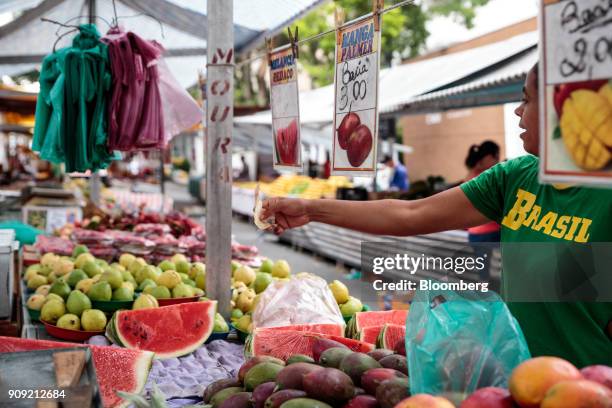 Customer makes a purchase at a fruit stall in an outdoor market in Sao Paulo, Brazil, on Thursday, Jan. 11, 2018. The Getulio Vargas Foundation is...