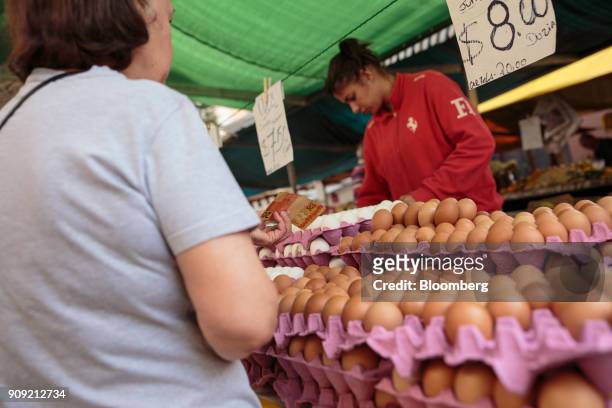 Customer purchases eggs for sale at an outdoor market in Sao Paulo, Brazil, on Thursday, Jan. 11, 2018. The Getulio Vargas Foundation is scheduled to...