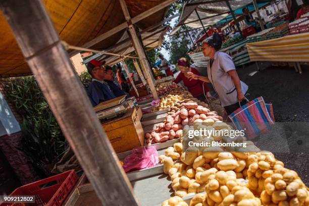 Customer speaks with a vendor selling potatoes at an outdoor market in Sao Paulo, Brazil, on Thursday, Jan. 11, 2018. The Getulio Vargas Foundation...