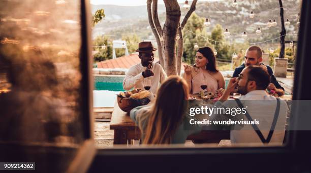 jungen multi-ethnischen freunde und paare beim mittagessen im dorfhaus - couple fine dining stock-fotos und bilder