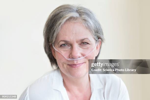 female patient with nasal cannula - medical oxygen equipment stock pictures, royalty-free photos & images