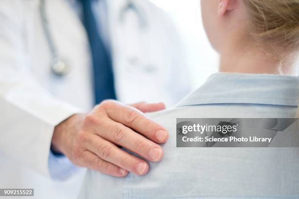male doctor with hand on patients shoulder - man touching shoulder stock-fotos und bilder