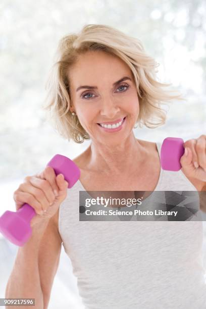 mature woman using hand weights - hand weight stock pictures, royalty-free photos & images