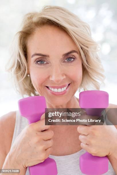 mature woman using hand weights - hand weight stock pictures, royalty-free photos & images