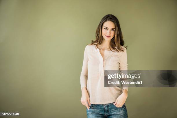 portrait of woman against green background - white blouse stock pictures, royalty-free photos & images