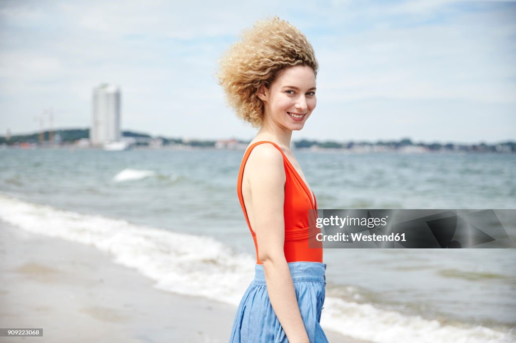 Portrait of smiling young woman on the beach
