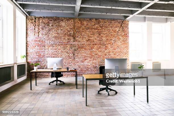 coworking space with brick wall in office - loft vacio fotografías e imágenes de stock