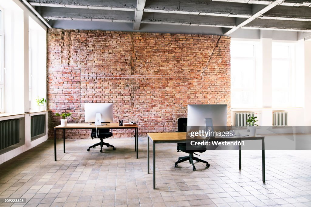 Coworking space with brick wall in office