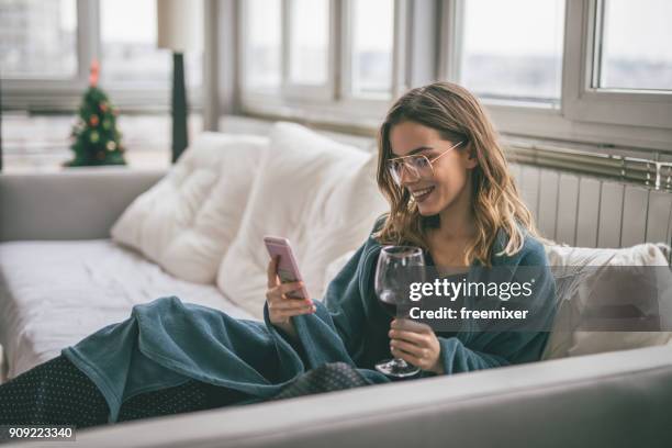 woman using cell phone - drinking alcohol at home stock pictures, royalty-free photos & images