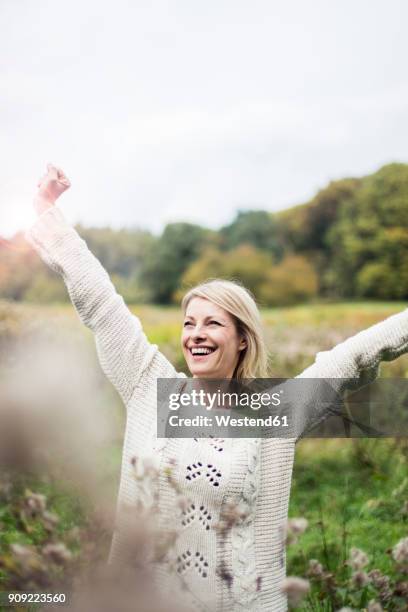 portrait of happy blond woman outdoors - natural blonde stock-fotos und bilder