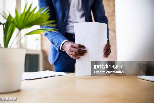 close-up of businessman with papers at desk in office - tidy desk stock pictures, royalty-free photos & images