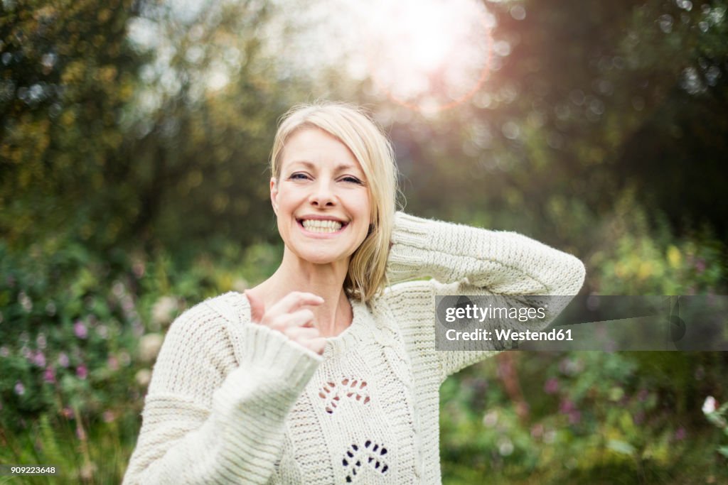 Portrait of happy blond woman outdoors