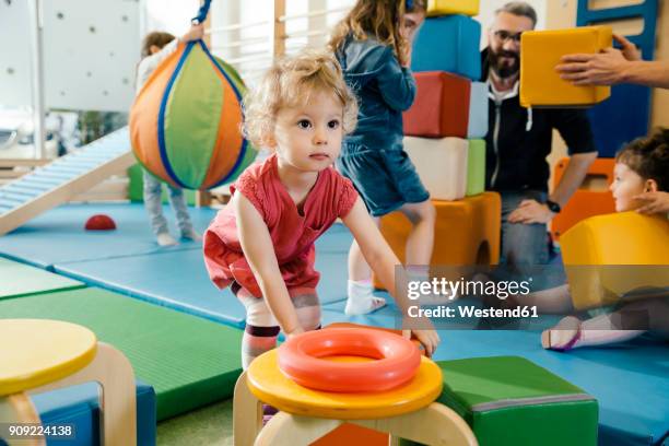 little girl playing in gym room of a kindergarten - 3 gym stock-fotos und bilder