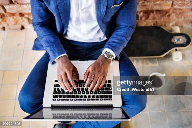 top view of businessman sitting on longboard using laptop - businessman working on a laptop with a coffee stock pictures, royalty-free photos & images