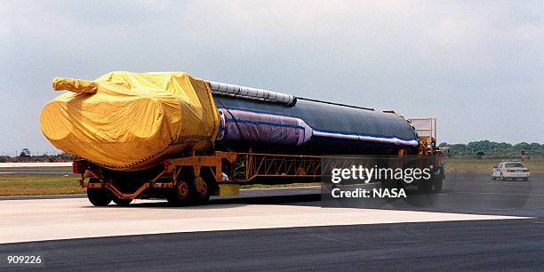 At Cape Canaveral Air Station, workers begin offloading a Centaur upper stage from a U.S. Air Force C-5c April 7, 1999. After being mated with the...