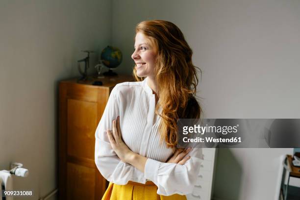 smiling young woman in office looking sideways - white blouse imagens e fotografias de stock
