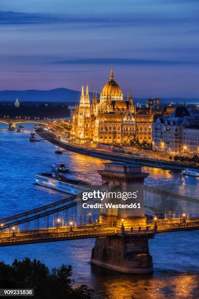 hungary, budapest, tranquil evening in the city with lit up hungarian parliament and chain bridge on danube river - hungarian parliament building stock pictures, royalty-free photos & images